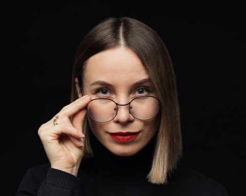 Woman portrait wearing eyewear on black background