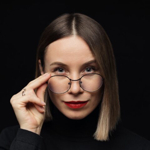 Woman portrait wearing eyewear on black background
