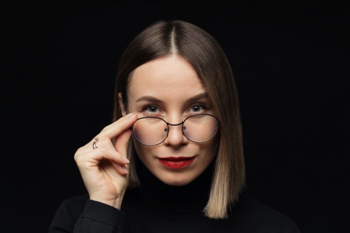 Woman portrait wearing eyewear on black background