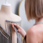 Designer checks stylish macrame decorative element for dress in fashion atelier outfit trend