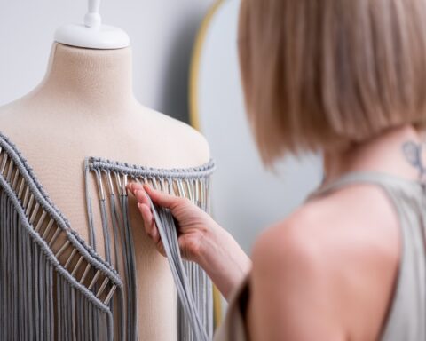 Designer checks stylish macrame decorative element for dress in fashion atelier outfit trend