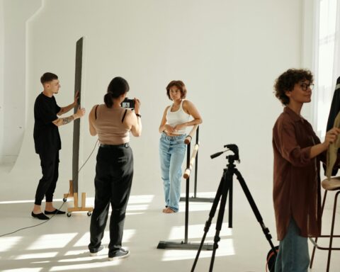 Long shot of shooting team carrying out their work during y2k fashion photo session