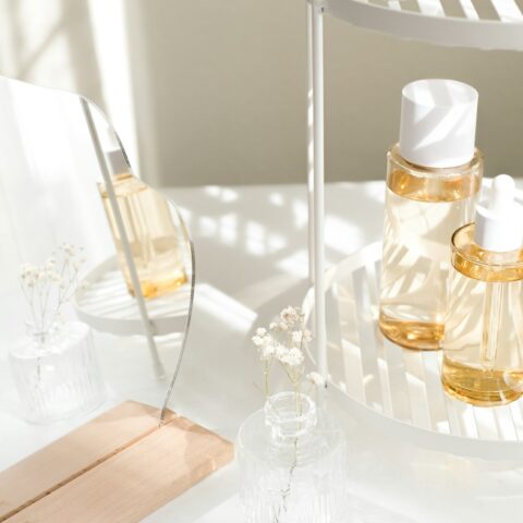 Skincare and cosmetic product with mirror and flower.