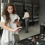 Young brunette female consumer choosing ring in jewelry shop