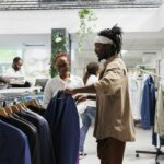 Buyer and seller discussing fashion trends while choosing jacket