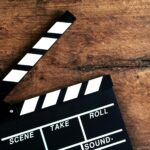 Movie clapper on old wooden background