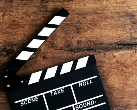 Movie clapper on old wooden background
