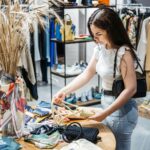 Sustainable fashion. Modern Latina young woman choosing handmade knitted handbag, in eco-friendly