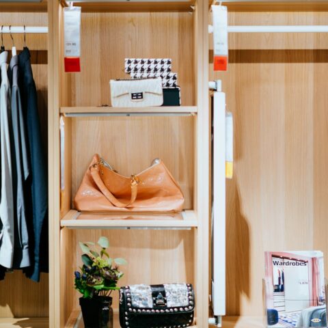 brown leather bag in shelf