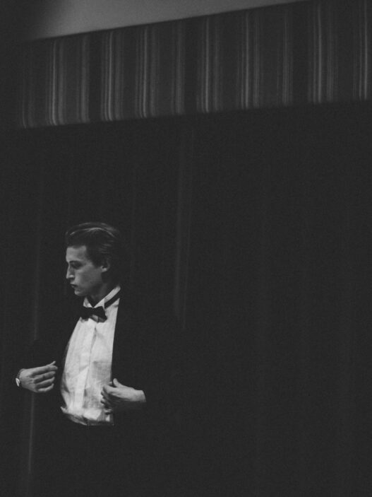 man in black vest and white dress shirt