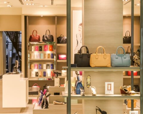 Chic boutique with a variety of handbags and shoes elegantly displayed on shelves.