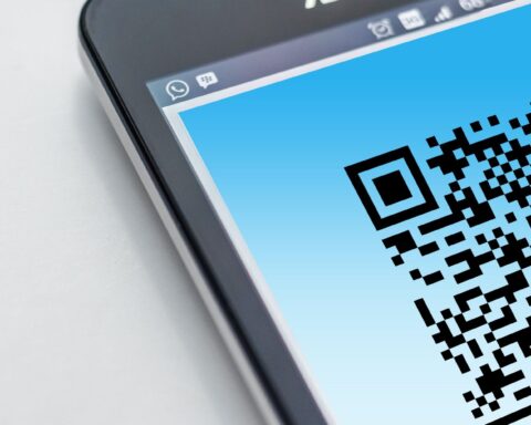 High-resolution close-up of a smartphone displaying a QR code on its screen.