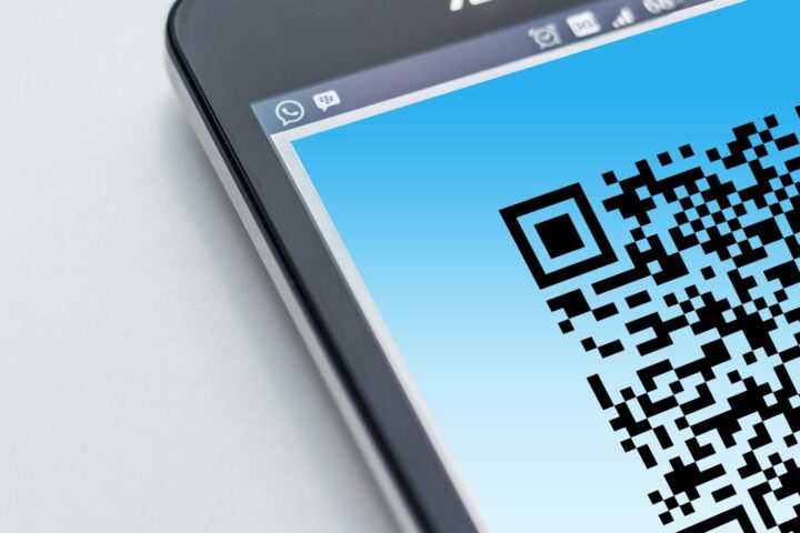 High-resolution close-up of a smartphone displaying a QR code on its screen.