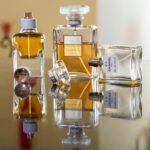 Luxury perfume bottles elegantly arranged, creating stunning reflections showcasing brand elegance.