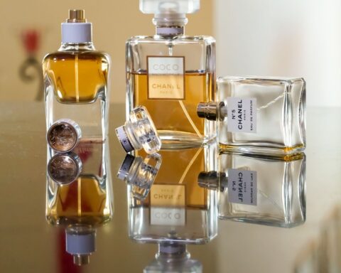 Luxury perfume bottles elegantly arranged, creating stunning reflections showcasing brand elegance.