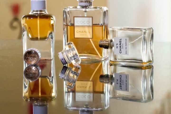 Luxury perfume bottles elegantly arranged, creating stunning reflections showcasing brand elegance.