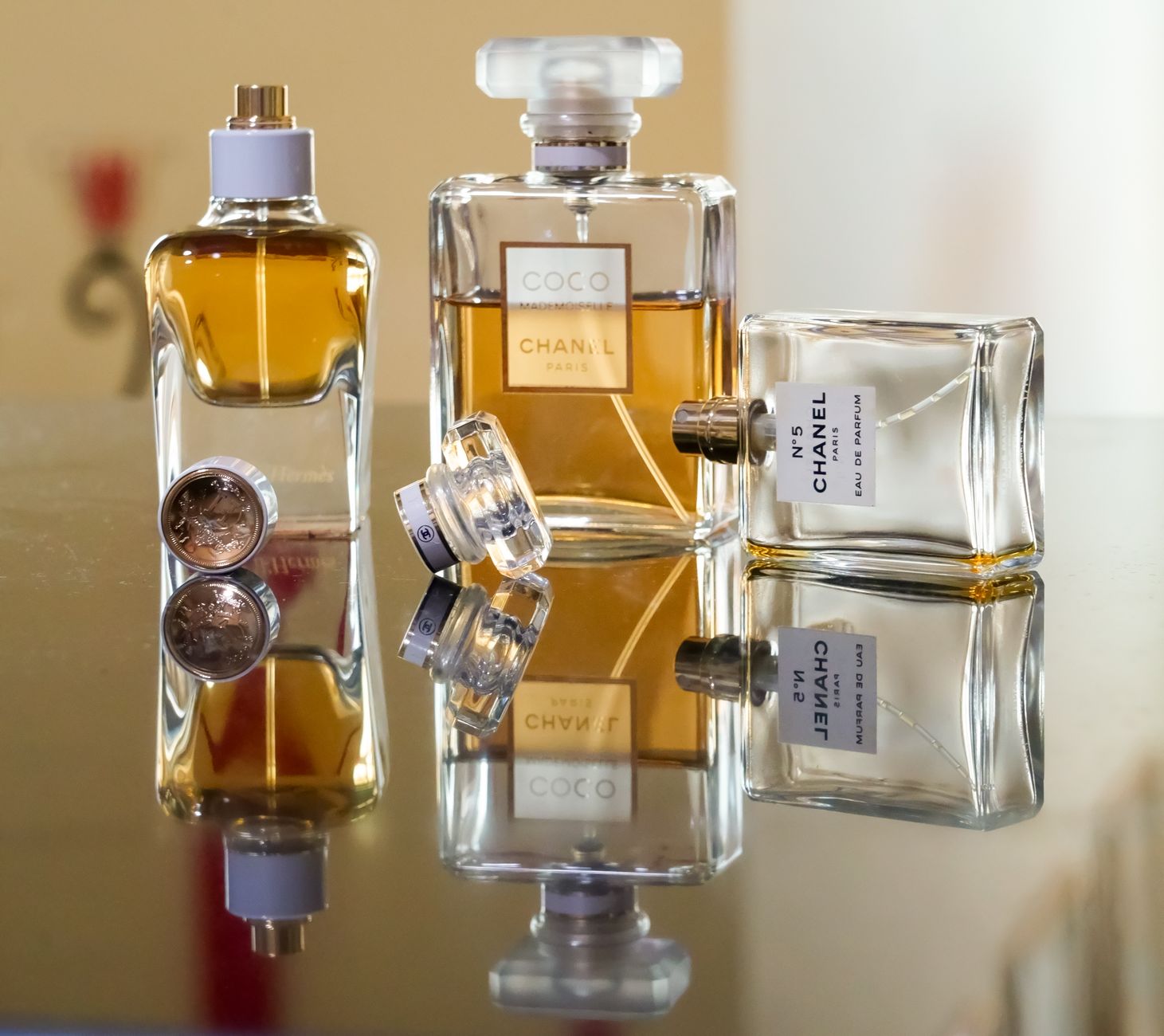 Luxury perfume bottles elegantly arranged, creating stunning reflections showcasing brand elegance.