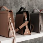 Luxury leather handbags displayed on a shelf, illustrating brand protection work in fashion law