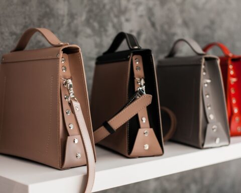 Luxury leather handbags displayed on a shelf, illustrating brand protection work in fashion law