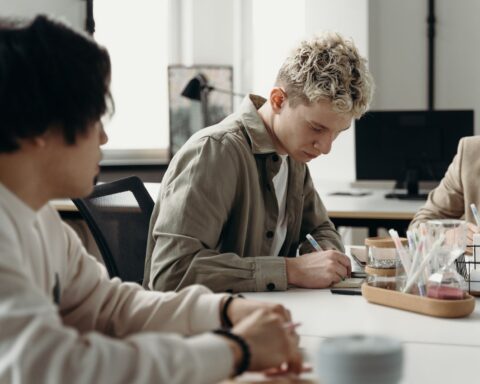 A young professional taking notes at a desk, illustrating a legal internship