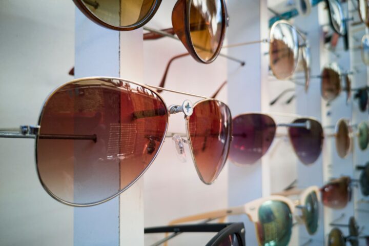 A display of sunglasses in varied styles, illustrating licensed eyewear ranges in fashion