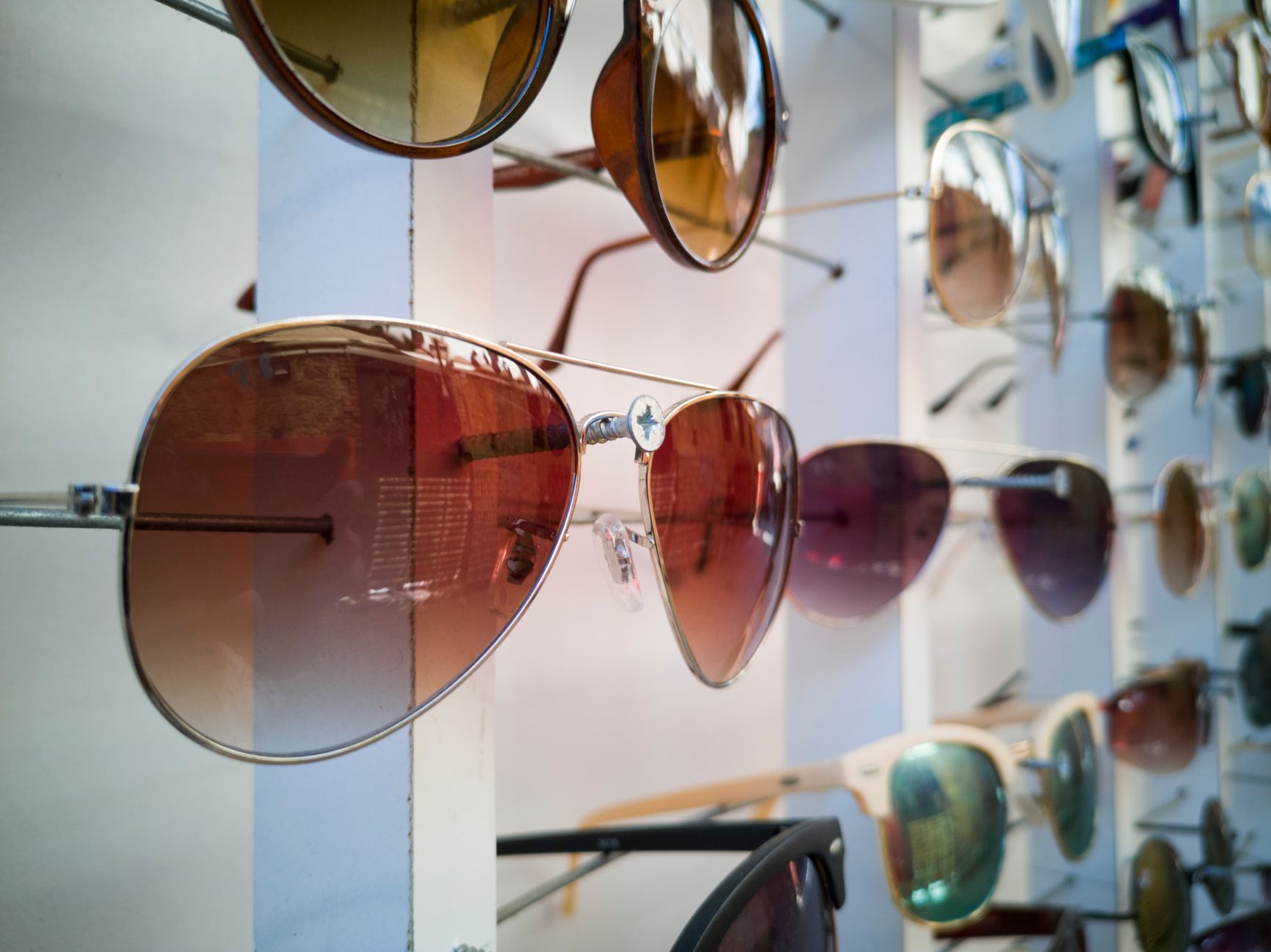 A display of sunglasses in varied styles, illustrating licensed eyewear ranges in fashion