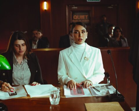 Two lawyers reviewing legal documents in a courtroom, illustrating fashion litigation practice