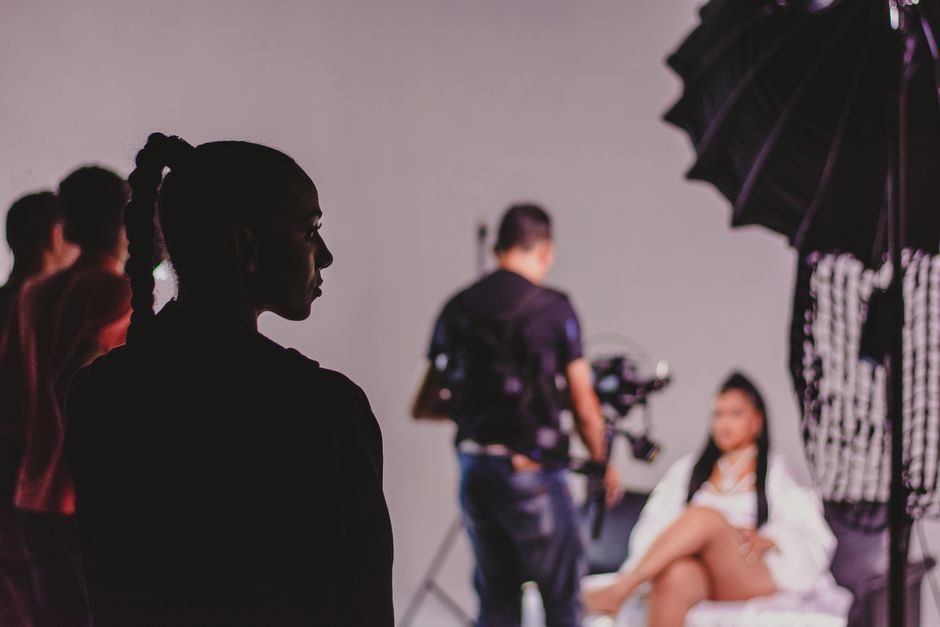 Capturing the essence of a fashion photo shoot with models and photographers in a studio.