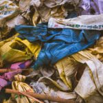 A vibrant mix of discarded textile bags in a recycling pile, showcasing the importance of waste management.