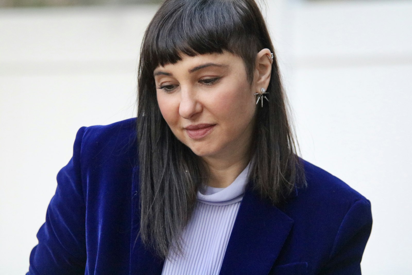 Woman in a deep blue velvet blazer
