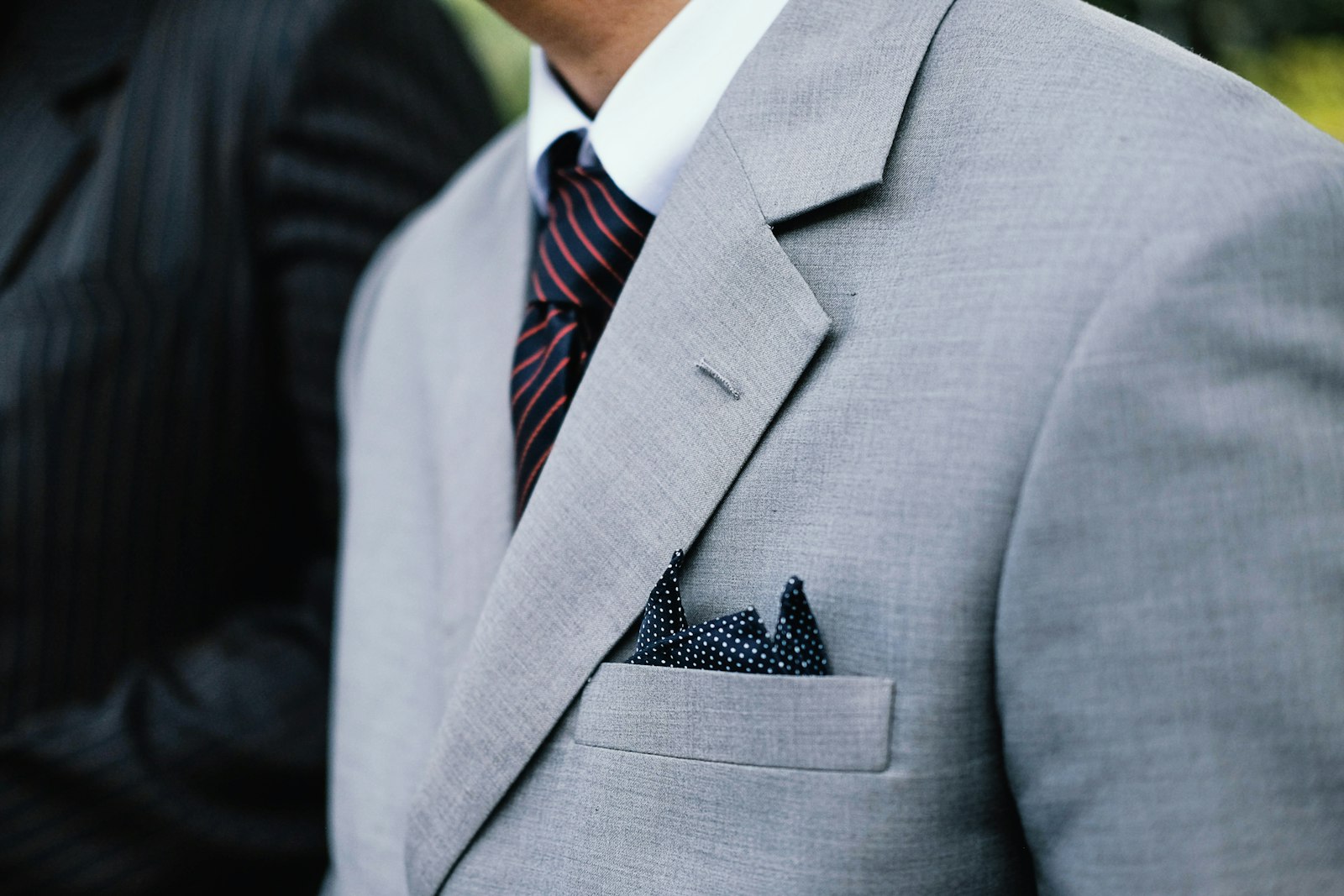 Man in a grey suit with a patterned tie