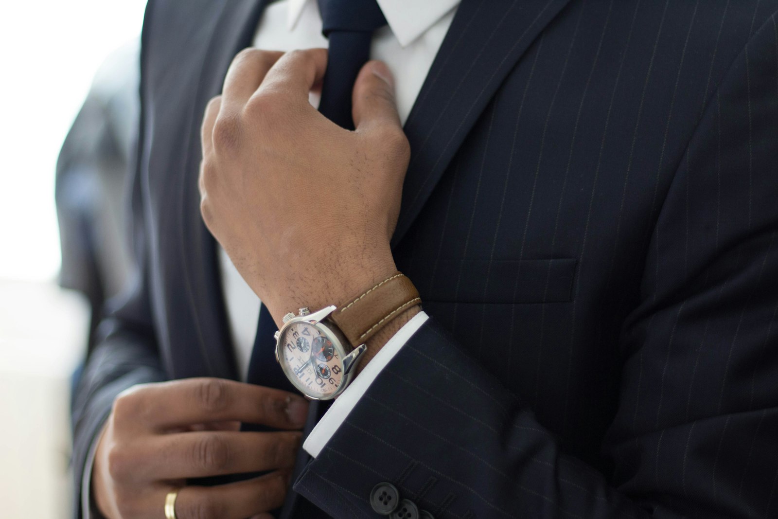 Man adjusting his tie and jacket