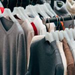Racks of low-cost knitwear on plastic hangers, illustrating the question is Shein legit and fast fashion law