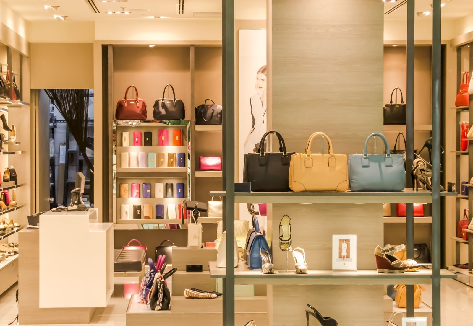 Leather handbags and shoes without logos on lit shelves in a luxury boutique, illustrating LVMH brands